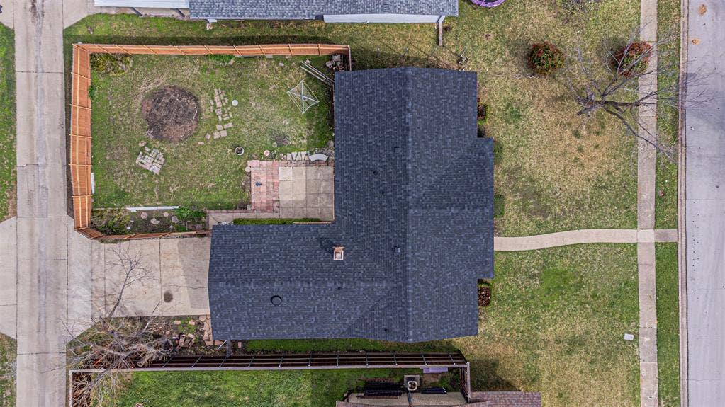1509 Crockett Street, Garland, TX 75042 Aerial view featuring a fenced-in rear yard, concrete patio, asphalt shingle roof, and paved driveway