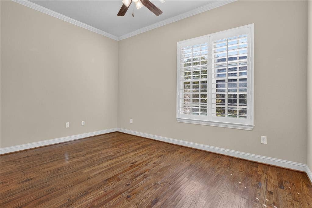 563 Rockingham Drive, Irving, TX 75063 Wood-finish flooring, crown molding, white plantation shutters, and a ceiling fan with integrated lighting