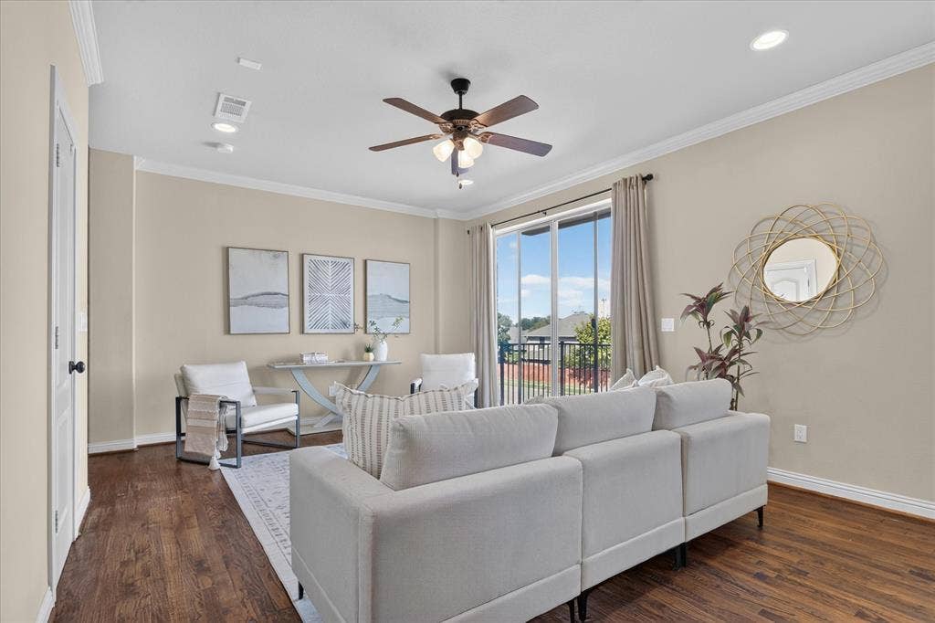 563 Rockingham Drive, Irving, TX 75063 Flex space featuring handscraped hardwood flooring, full bath, two large walk in closets, laundry room, and a large wet-bar with cabinets, mini sink and mini-fridge. Sliding glass door leads to balcony with winding staircase down to covered patio.