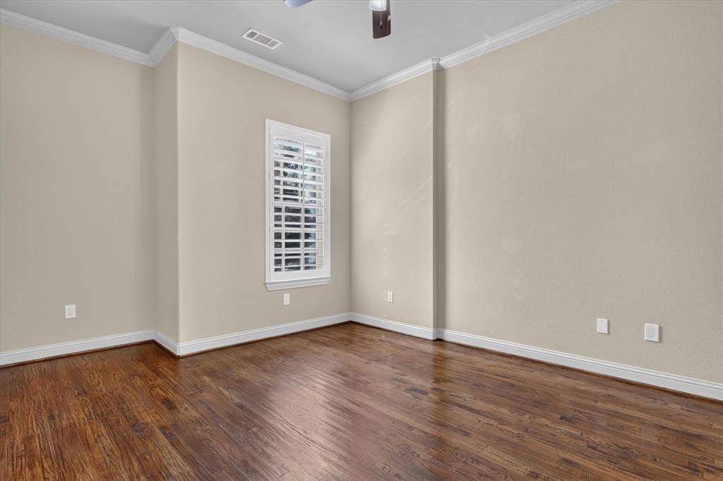 563 Rockingham Drive, Irving, TX 75063 Interior room featuring wood-finish flooring, neutral wall paint, crown molding, and plantation shutters
