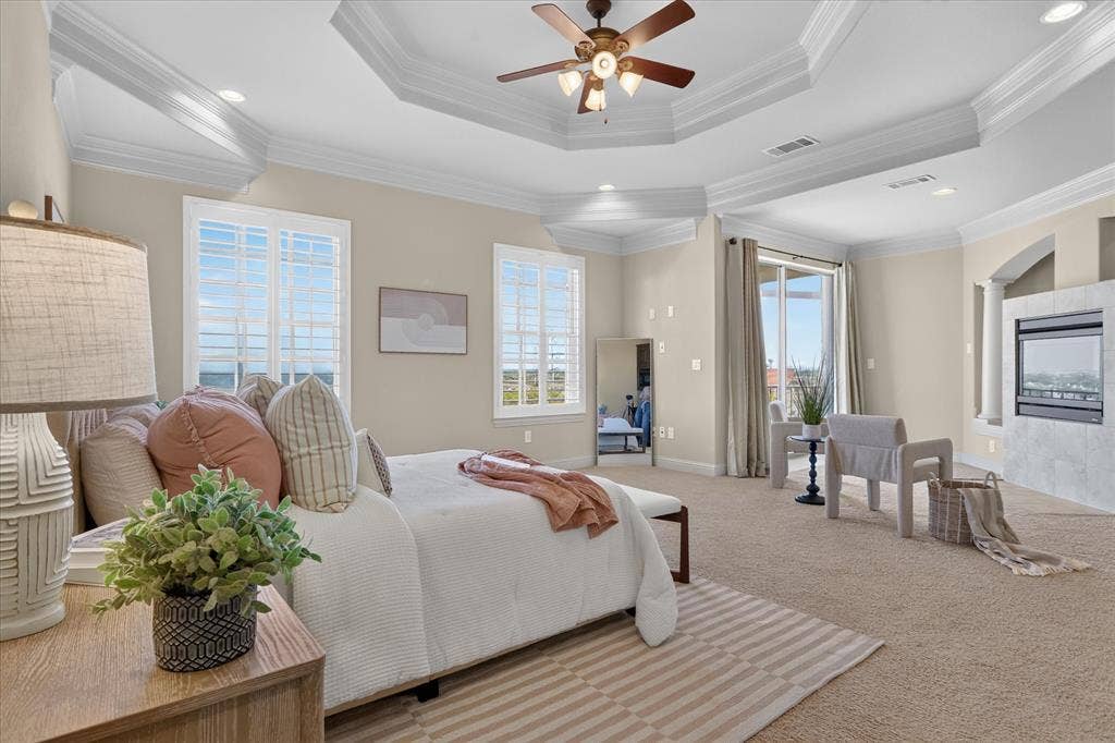 563 Rockingham Drive, Irving, TX 75063 Tray ceiling, recessed lighting, ceiling fan with light kit, plantation shutters, and stone-surround fireplace