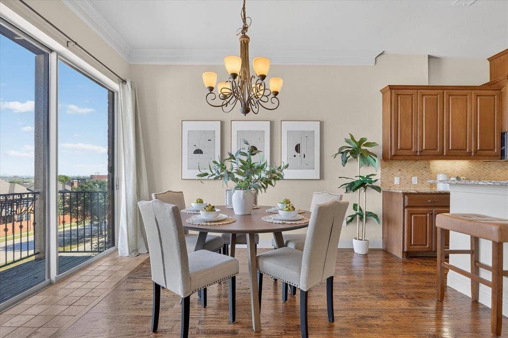 563 Rockingham Drive, Irving, TX 75063 Wood-finish flooring, full-height sliding glass doors, decorative multi-arm chandelier, and natural wood cabinetry