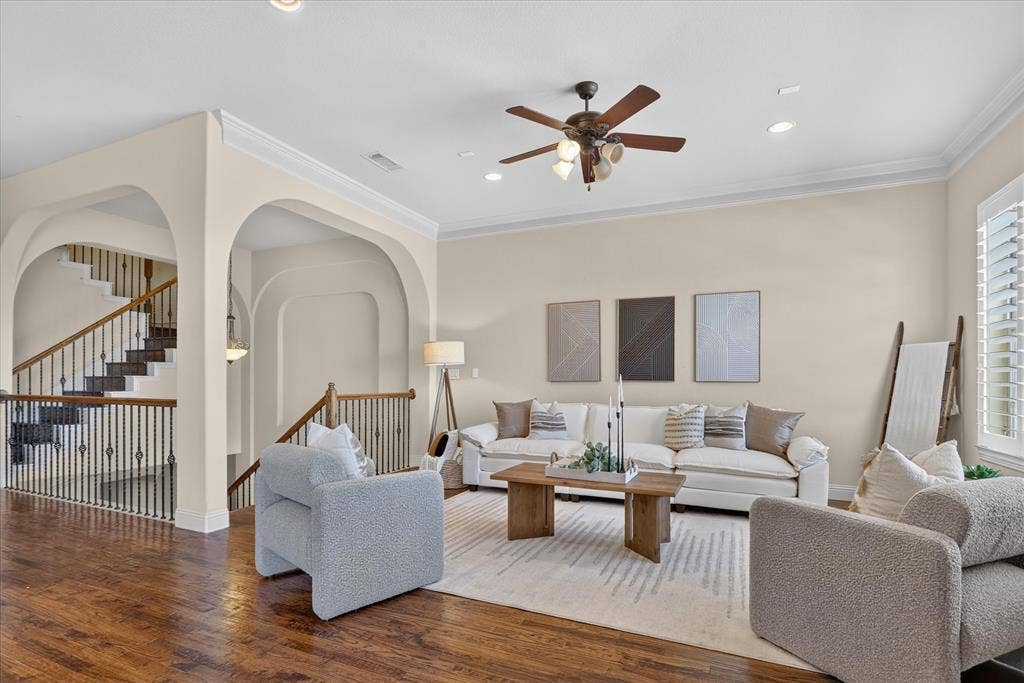 563 Rockingham Drive, Irving, TX 75063 Living area featuring wood-finish flooring, crown molding, arched entryways, recessed lighting, and a ceiling fan with integrated light fixtures