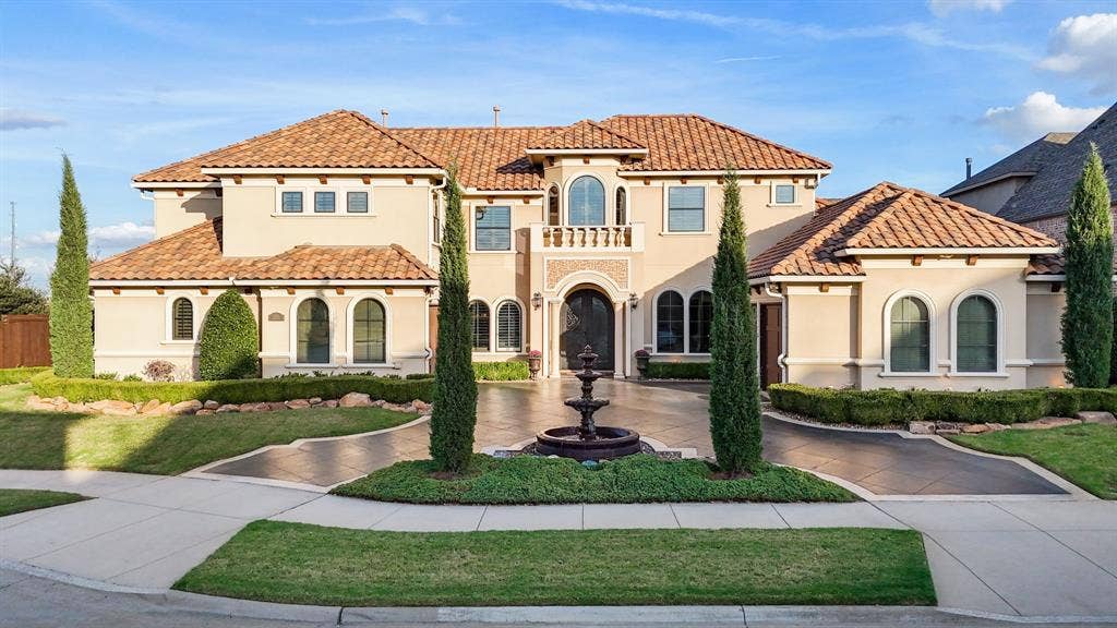 6590 Gerrard Street, Frisco, TX 75034 Mediterranean-style exterior featuring a stucco facade, tile roof, arched windows, grand gated entry, and a decorative fountain