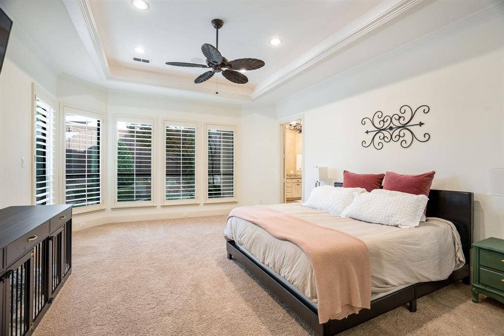 6590 Gerrard Street, Frisco, TX 75034 Tray ceiling with recessed lighting, ceiling fan, carpeted flooring, and plantation shutters on multi-pane windows