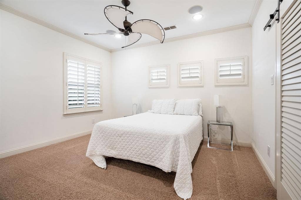 6590 Gerrard Street, Frisco, TX 75034 Room featuring crown molding, neutral carpeting, plantation shutters, recessed lighting, and a dual-blade ceiling fan
