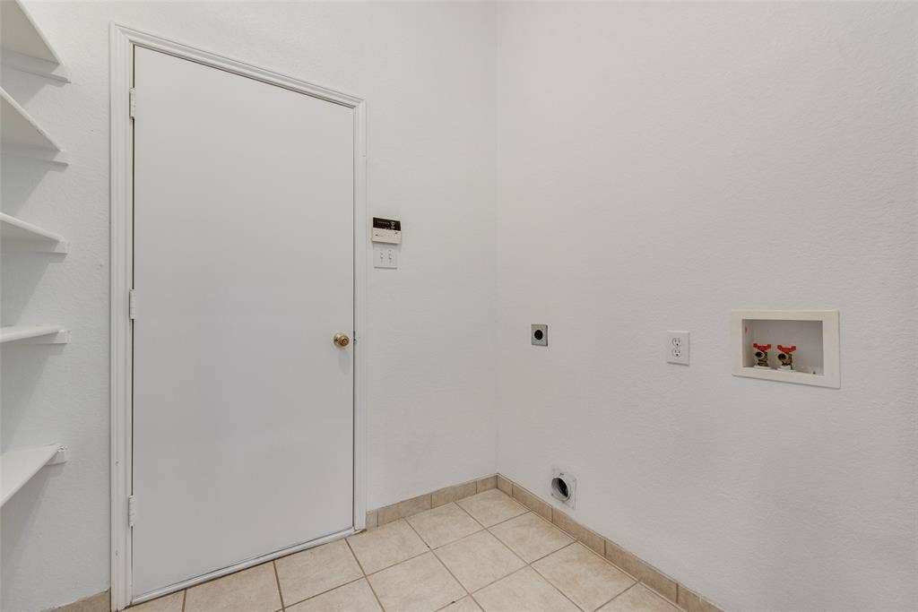 412 Overland Trail, Cedar Hill, TX 75104 Utility space featuring ceramic tile flooring, built-in wall shelving, and dedicated hookups for laundry appliances