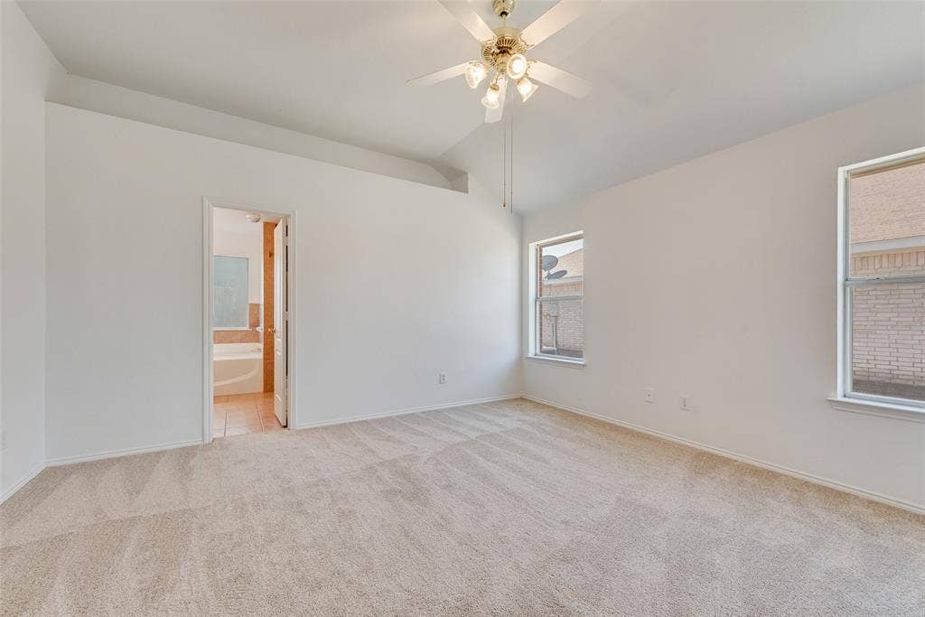 412 Overland Trail, Cedar Hill, TX 75104 Interior space featuring vaulted ceilings, neutral wall-to-wall carpeting, and a multi-light ceiling fan