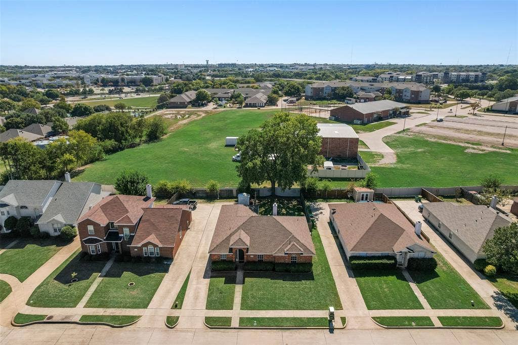 412 Overland Trail, Cedar Hill, TX 75104 Aerial perspective of a suburban neighborhood featuring brick-exterior single-story and two-story homes, expansive rear lot space, mature trees, and paved driveways