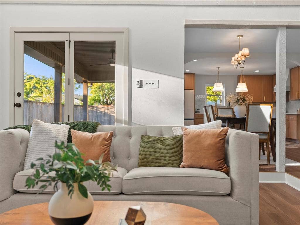 Double glass patio doors, wood-finish flooring, and recessed ceiling lighting