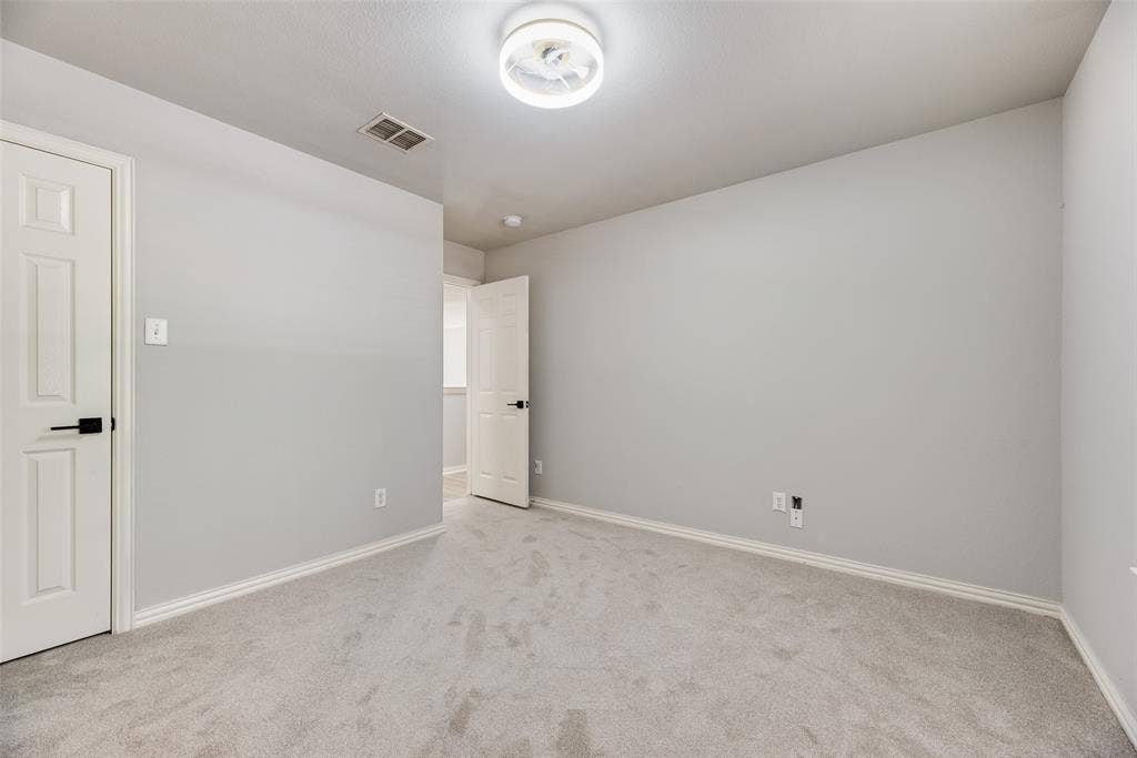 1716 Clarke Springs Drive, Allen, TX 75002 Neutral-toned wall paint, plush carpeting, multi-panel doors with matte black hardware, and a circular flush-mount ceiling fixture