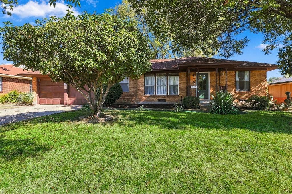 2810 Bonnie View Road, Dallas, TX 75216 Single-story brick exterior featuring a covered front porch, attached two-car garage, and established landscaping