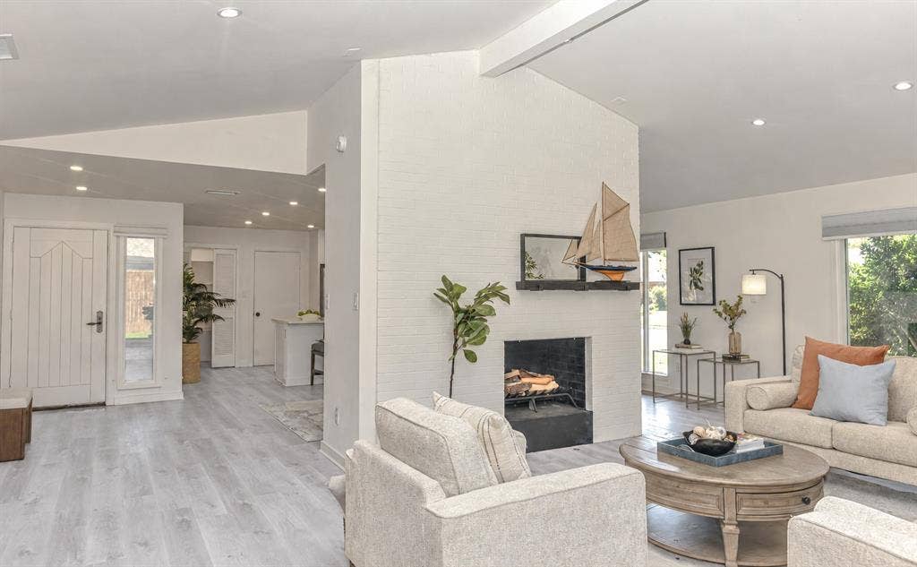13936 Tanglewood Place, Farmers Branch, TX 75234 When the nights turn chilly, this white painted brick fireplace ,featuring a black hearth, will warm the mood