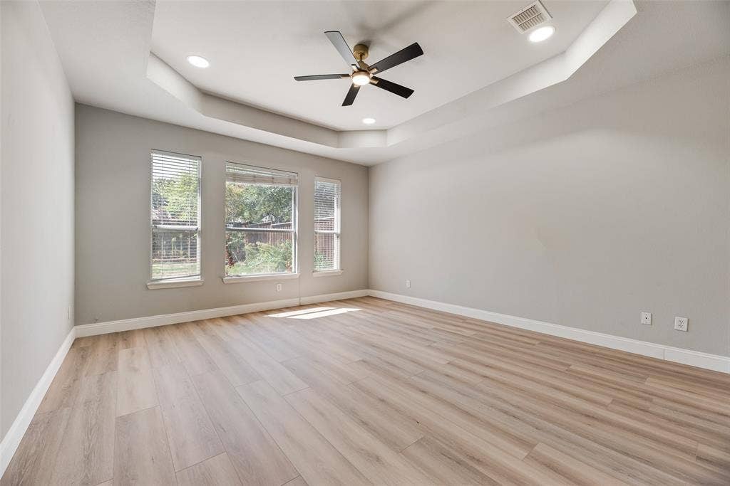 1716 Clarke Springs Drive, Allen, TX 75002 Room featuring a tray ceiling, wood-finish flooring, recessed lighting, and a multi-blade ceiling fan with an integrated light fixture