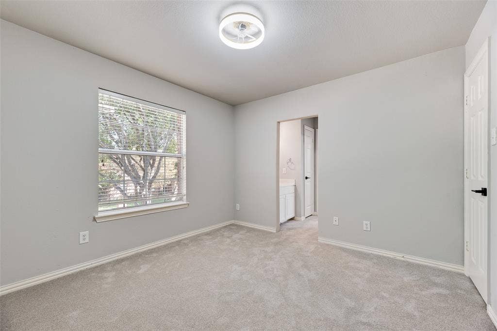 1716 Clarke Springs Drive, Allen, TX 75002 Neutral-toned room featuring neutral carpeting, a dual-function ceiling light and fan fixture, and a single-panel window with horizontal blinds
