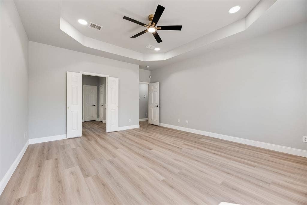 1716 Clarke Springs Drive, Allen, TX 75002 Tray ceiling with recessed lighting, wood-finish flooring, and a central ceiling fan with integrated light fixture