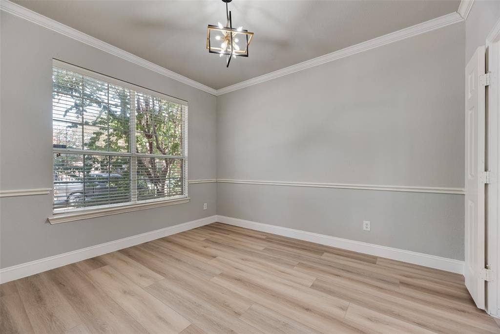 1716 Clarke Springs Drive, Allen, TX 75002 Room featuring wood-finish flooring, crown molding, chair rail trim, large window with neutral blinds, and an industrial-style geometric chandelier