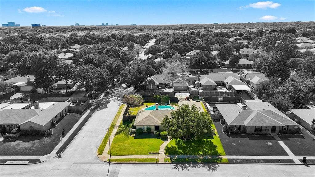 1900 Ports O Call Drive, Plano, TX 75075 Aerial perspective featuring a single-story residence on a corner lot with an inground pool and mature landscaping