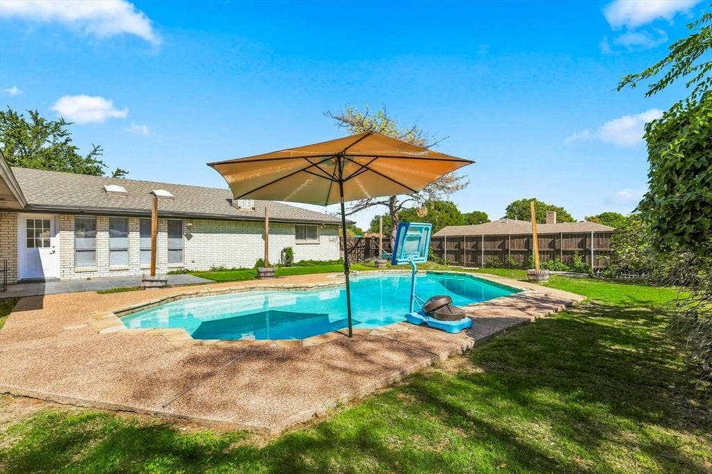 1900 Ports O Call Drive, Plano, TX 75075 In-ground swimming pool with a concrete surround, brick exterior, skylights, and wood-fence perimeter