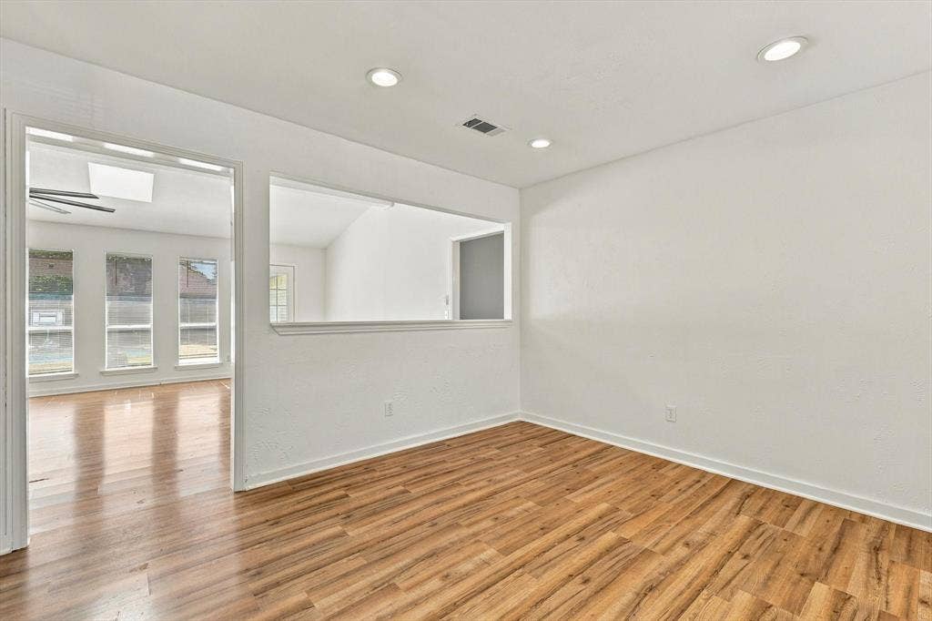 1900 Ports O Call Drive, Plano, TX 75075 Interior space featuring wood-finish flooring, recessed lighting, and a window-style pass-through opening