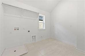 15638 Kestrel Mews, Frisco, TX 75035 Laundry room featuring vaulted ceilings, neutral tile flooring, built-in wall shelving, and a singular window
