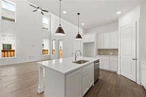 15638 Kestrel Mews, Frisco, TX 75035 Kitchen featuring a center island with quartz countertop, high-reach vaulted ceilings, recessed lighting, pendant light fixtures, and wood-finish flooring