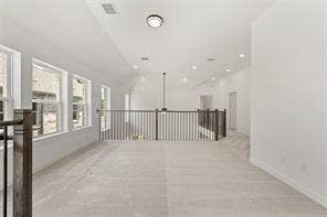 15638 Kestrel Mews, Frisco, TX 75035 Vaulted ceiling featuring recessed lighting, carpeted flooring, and a dark metal balustrade with a wooden handrail