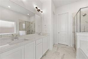 15638 Kestrel Mews, Frisco, TX 75035 Dual-sink vanity with light-tone countertops, full-width wall mirror, glass-enclosed shower, and large-format tile flooring