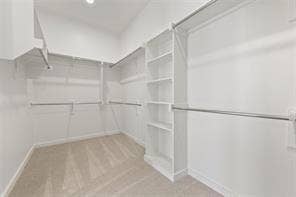 15638 Kestrel Mews, Frisco, TX 75035 Walk-in closet featuring wall-to-wall carpeting, white shelving units, multi-tier metal rods, and recessed lighting