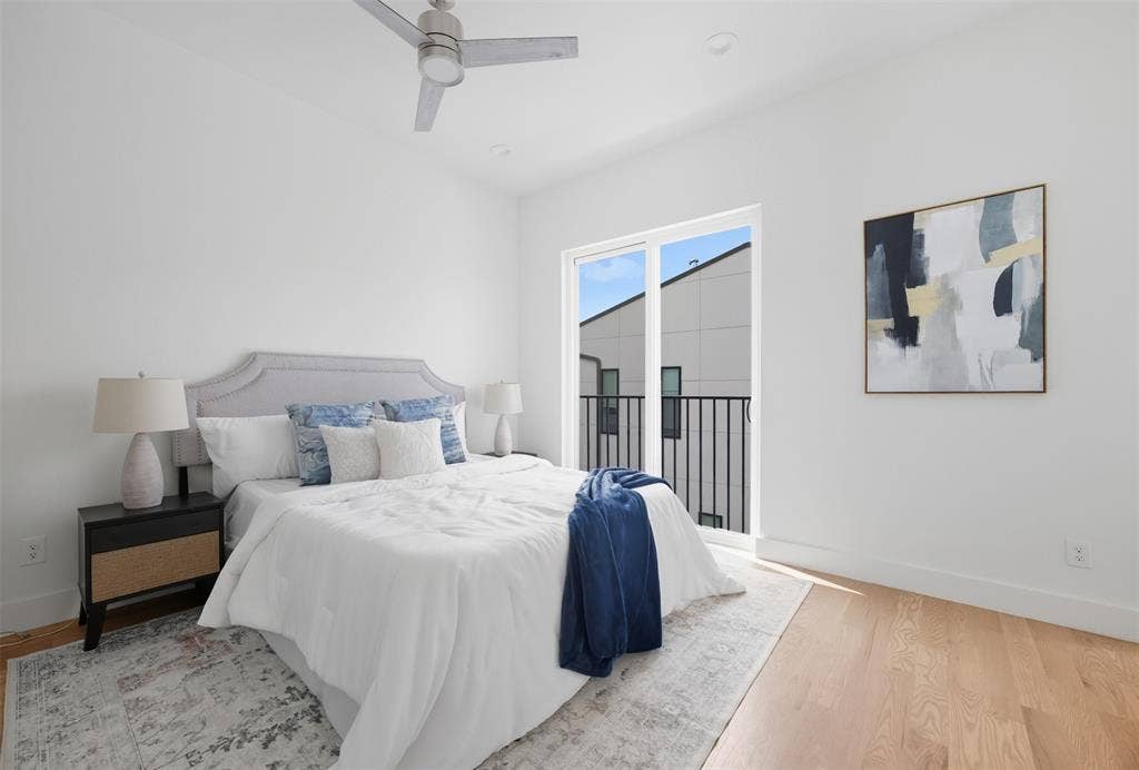 Room featuring wood-finish flooring, recessed lighting, a modern ceiling fan, and a glass door with a private balcony