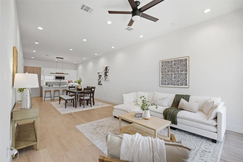 Open-concept interior featuring wood-finish flooring, recessed lighting, and a modern ceiling fan