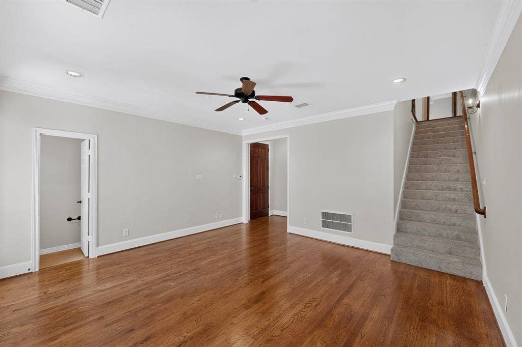 18359 Frankford Lakes Circle, Dallas, TX 75252 Interior space featuring wood-finish flooring, crown molding, recessed lighting, a ceiling fan, and carpeted staircase with a wooden handrail