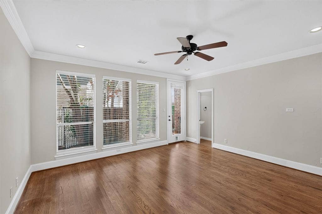 18359 Frankford Lakes Circle, Dallas, TX 75252 Living area featuring wood-finish flooring, crown molding, recessed lighting, a ceiling fan, and large windows with horizontal blinds