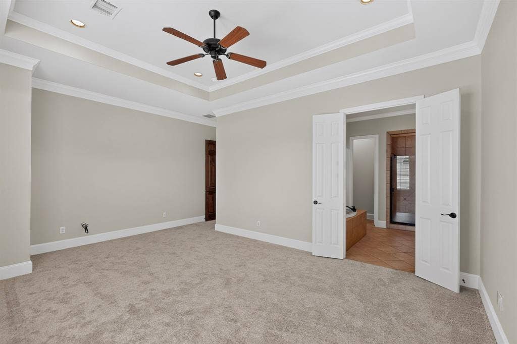 18359 Frankford Lakes Circle, Dallas, TX 75252 Tray ceiling with crown molding, ceiling-mounted fan, recessed lighting, and carpeted flooring