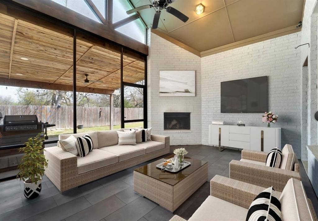 102 Champion Drive, Wylie, TX 75098 Screened porch featuring a vaulted ceiling with wood-paneled accents, white painted brick walls, tile flooring, and a corner fireplace