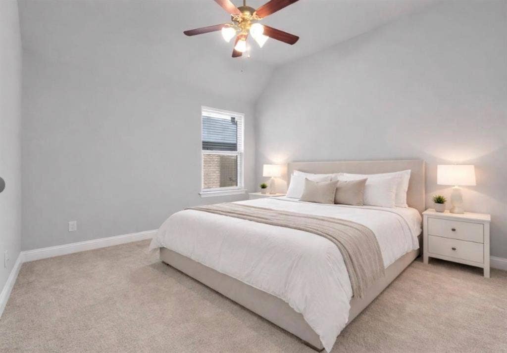102 Champion Drive, Wylie, TX 75098 Vaulted ceiling featuring a central multi-blade ceiling fan with integrated light fixture and neutral wall-to-wall carpeting