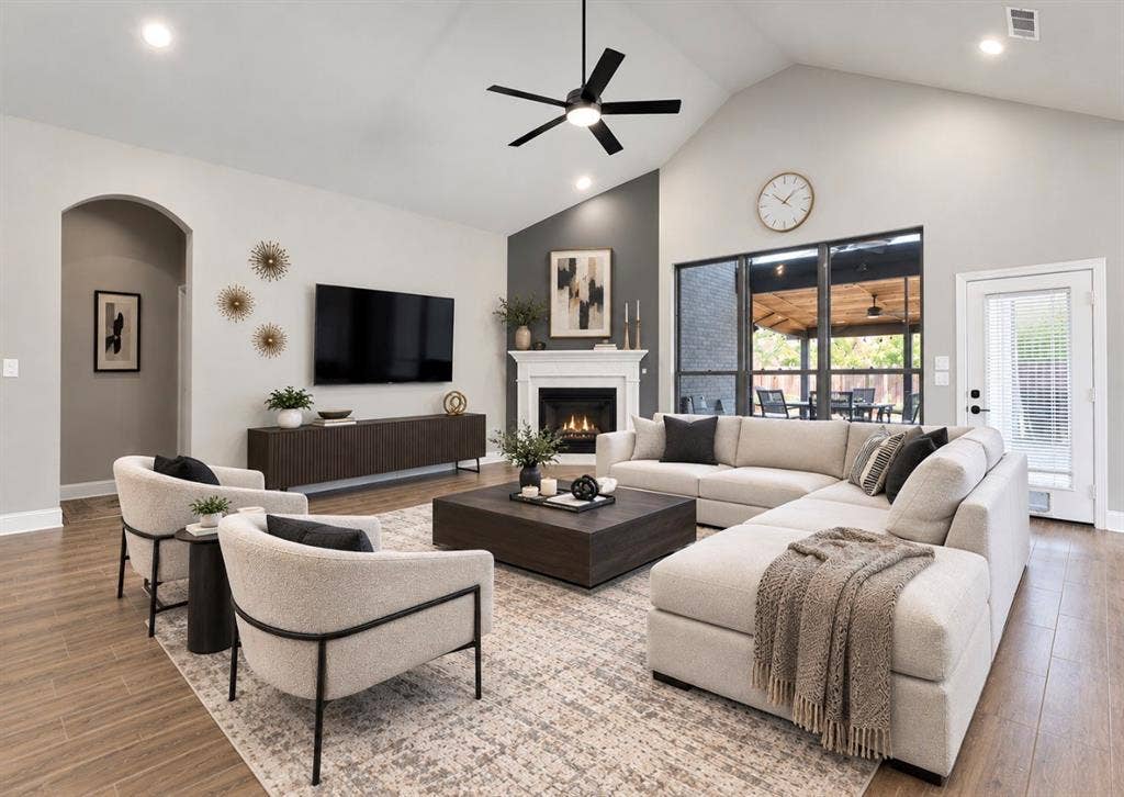 102 Champion Drive, Wylie, TX 75098 Vaulted ceilings, fireplace with a white mantel, wood-finish flooring, recessed lighting, and a modern ceiling fan