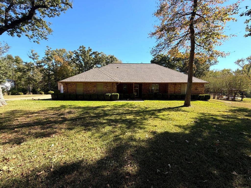 9031 Mallard Way, Larue, TX 75770 Single-story brick exterior featuring a hipped roof, covered entryway, and mature trees situated on a spacious lot