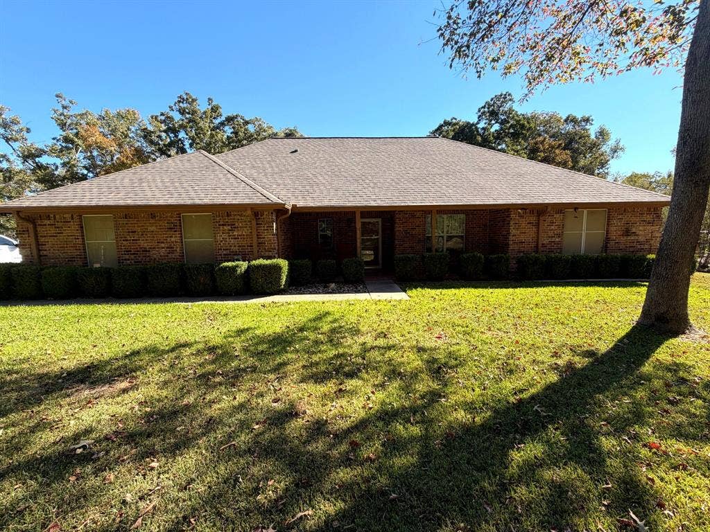 9031 Mallard Way, Larue, TX 75770 Single-story brick exterior featuring a hip roof, covered entryway, and manicured landscaping