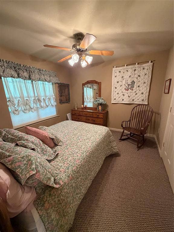 9031 Mallard Way, Larue, TX 75770 Bedroom featuring neutral-toned walls, textured wall-to-wall carpeting, and a multi-blade ceiling fan with integrated glass lighting