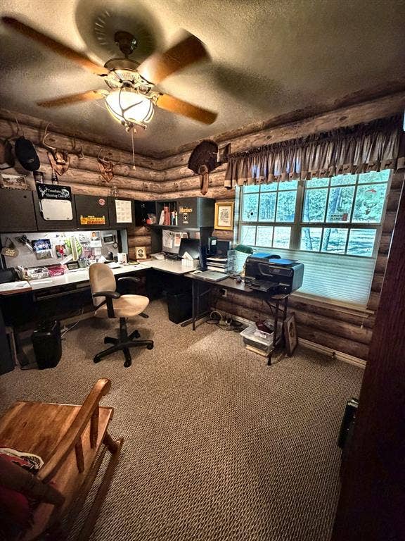 9031 Mallard Way, Larue, TX 75770 Log wall interior featuring a multi-pane window, built-in cabinetry, and a ceiling fan with light fixture