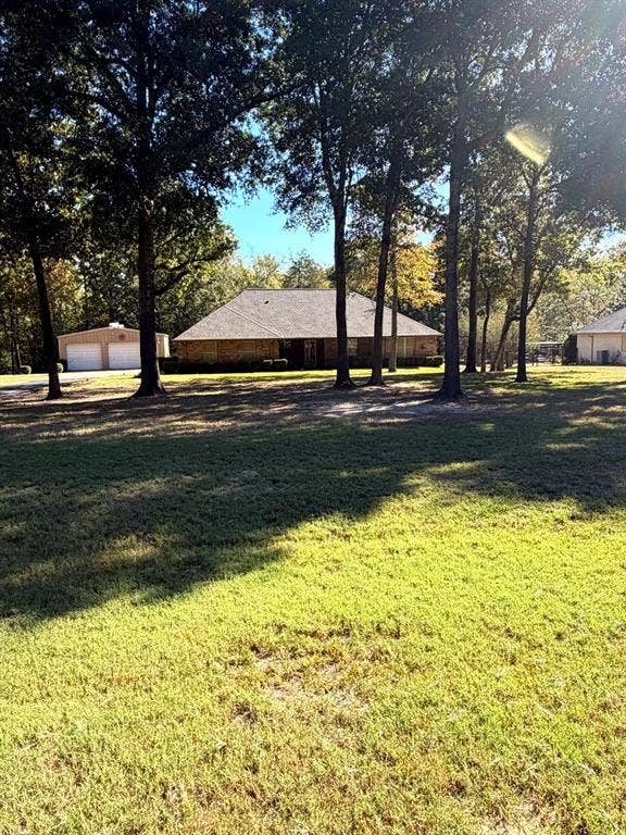 9031 Mallard Way, Larue, TX 75770 Expansive lot featuring mature trees, multi-structure property layout, and detached garage