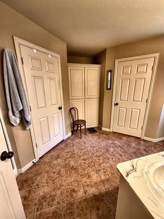 9031 Mallard Way, Larue, TX 75770 Tile flooring arranged in a diagonal pattern, white six-panel doors, and built-in floor-to-ceiling cabinetry with shaker-style panels