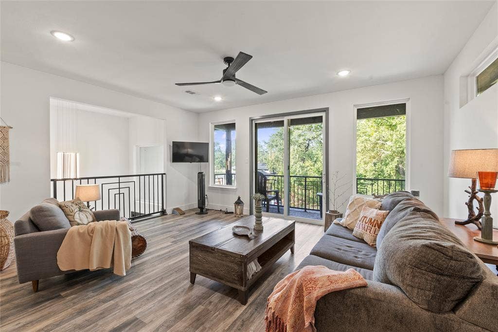 6113 Ottawa Trail, Mabank, TX 75156 Living area featuring wood-finish flooring, recessed lighting, a modern ceiling fan, sliding glass doors to a balcony, and decorative metal railings