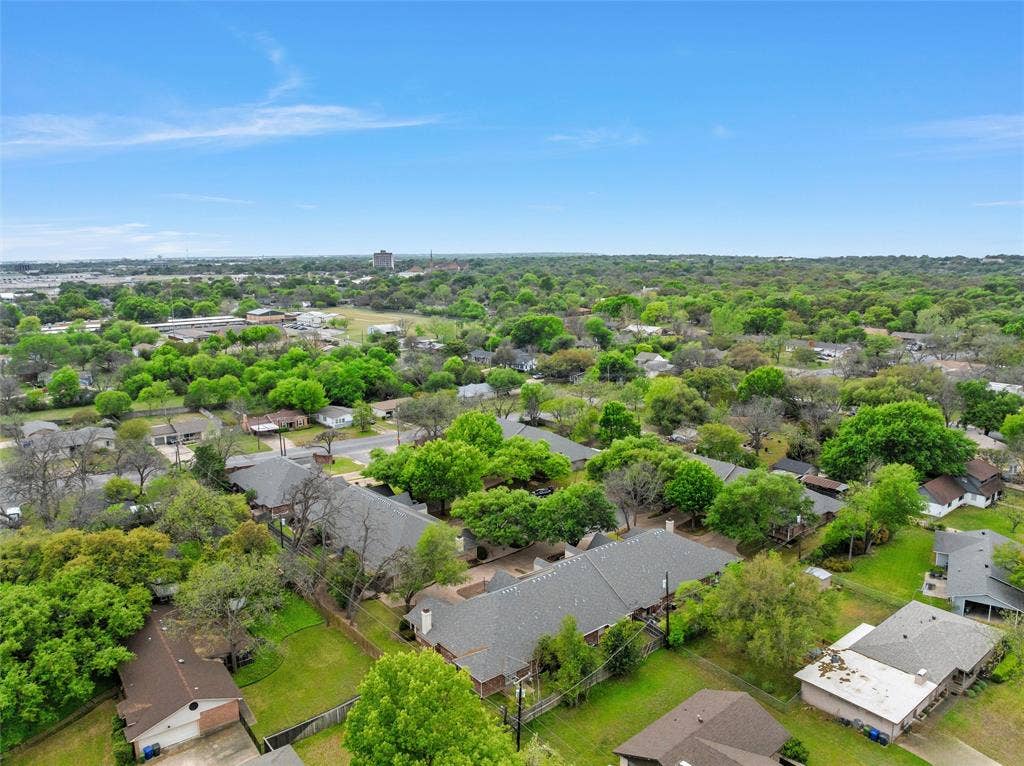 201 Pecan Village Circle, Waco, TX 76710 Aerial perspective featuring a residential lot with mature trees and expansive green space