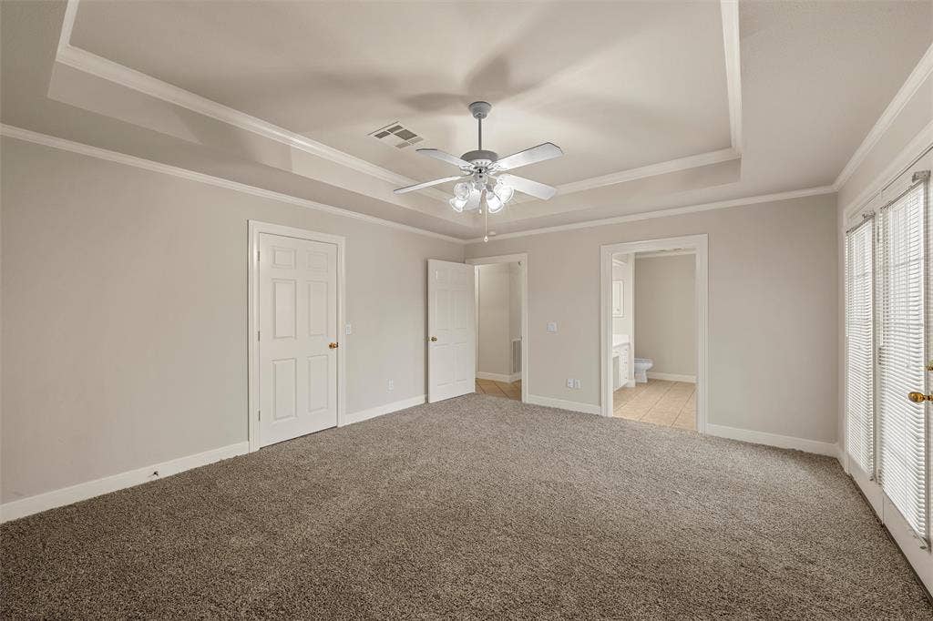 201 Pecan Village Circle, Waco, TX 76710 Tray ceiling, central ceiling fan with multi-light fixture, carpeted flooring, and double glass-paned doors