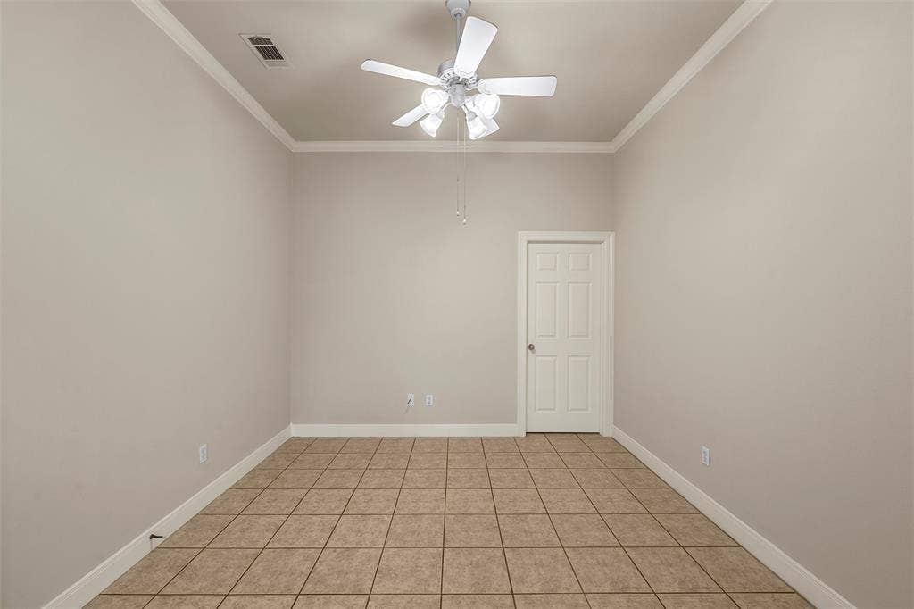 201 Pecan Village Circle, Waco, TX 76710 Room featuring neutral-toned walls, tile flooring, high ceilings with crown molding, and a four-blade ceiling fan with integrated lighting