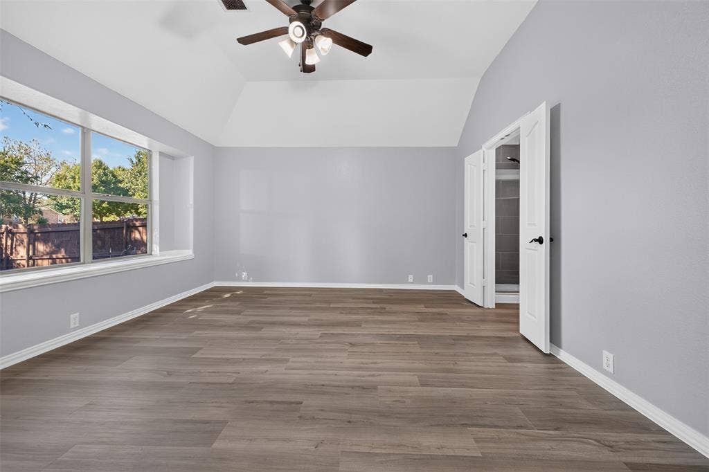 701 Abbey Lane, Midlothian, TX 76065 Vaulted ceiling with a central multi-light fan, wood-finish flooring, large window, and double-door entry