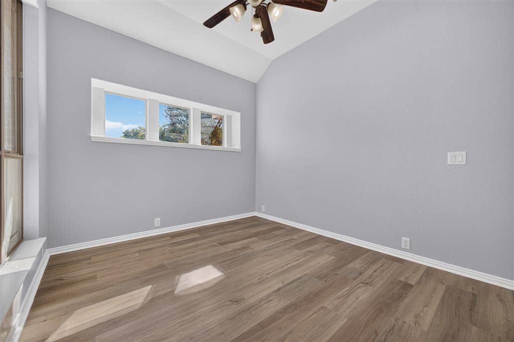 701 Abbey Lane, Midlothian, TX 76065 Vaulted ceiling, wood-finish flooring, horizontal window bank, and multi-blade ceiling fan