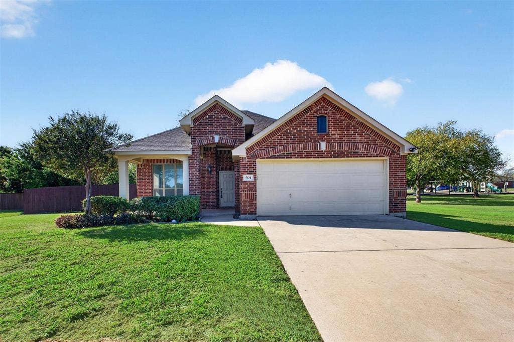 701 Abbey Lane, Midlothian, TX 76065 Single-story brick exterior featuring a multi-gable roofline, attached two-car garage, concrete driveway, and covered front entry